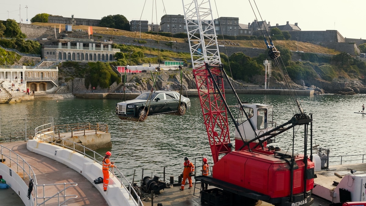car and crane by sea